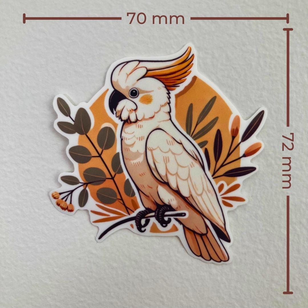 Sticker of a white cockatoo with an orange crest perched on a branch, surrounded by leaves and small orange flowers. The background is a warm orange tone, and the sticker measures 70 mm wide by 72 mm tall.
