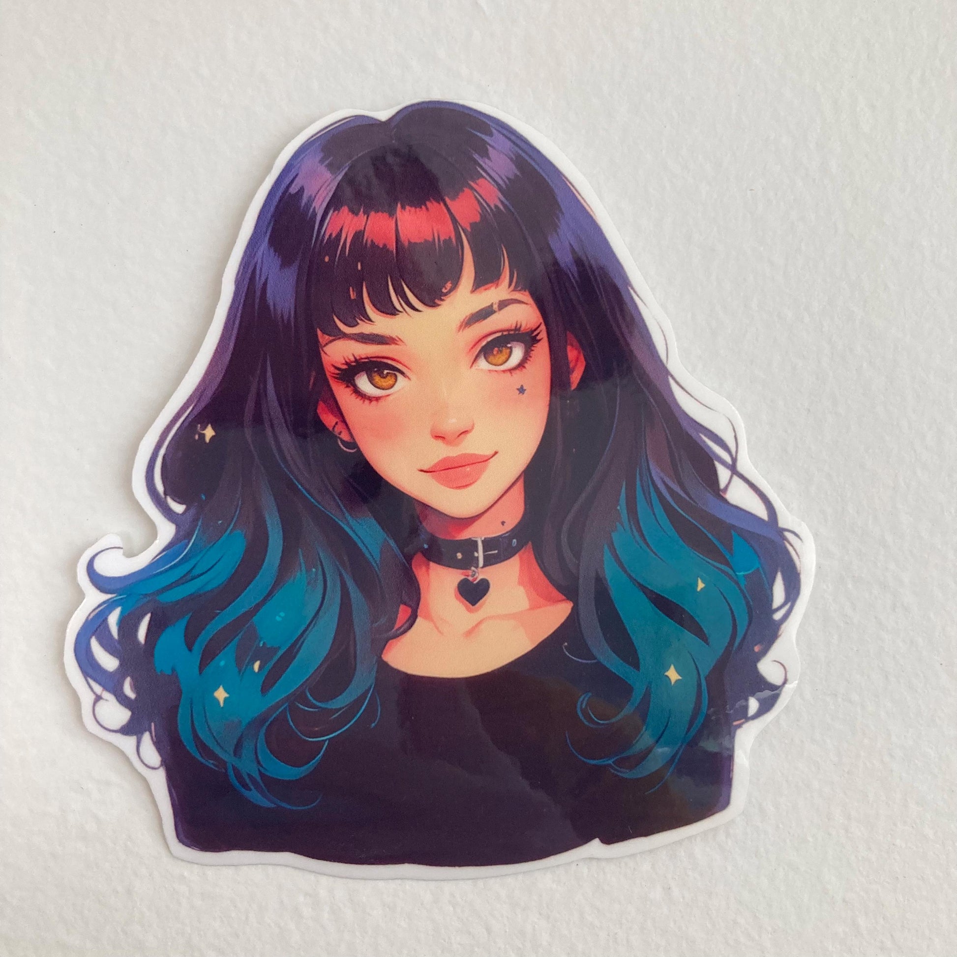 A sticker of an anime-style character with long black-to-teal gradient hair, bright eyes, and a heart choker, placed on a plain white surface.