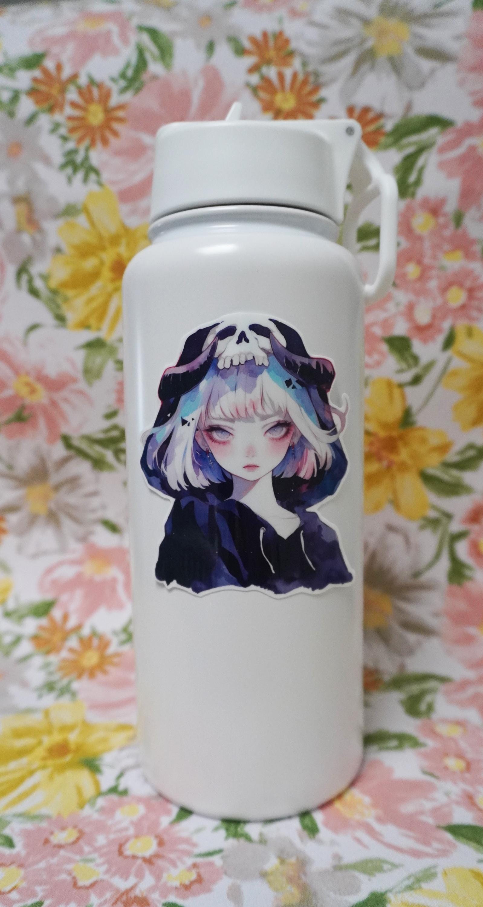 A white water bottle with a sticker of an anime-style character with silver hair, wearing a hood adorned with a skull design, set against a floral-patterned background.