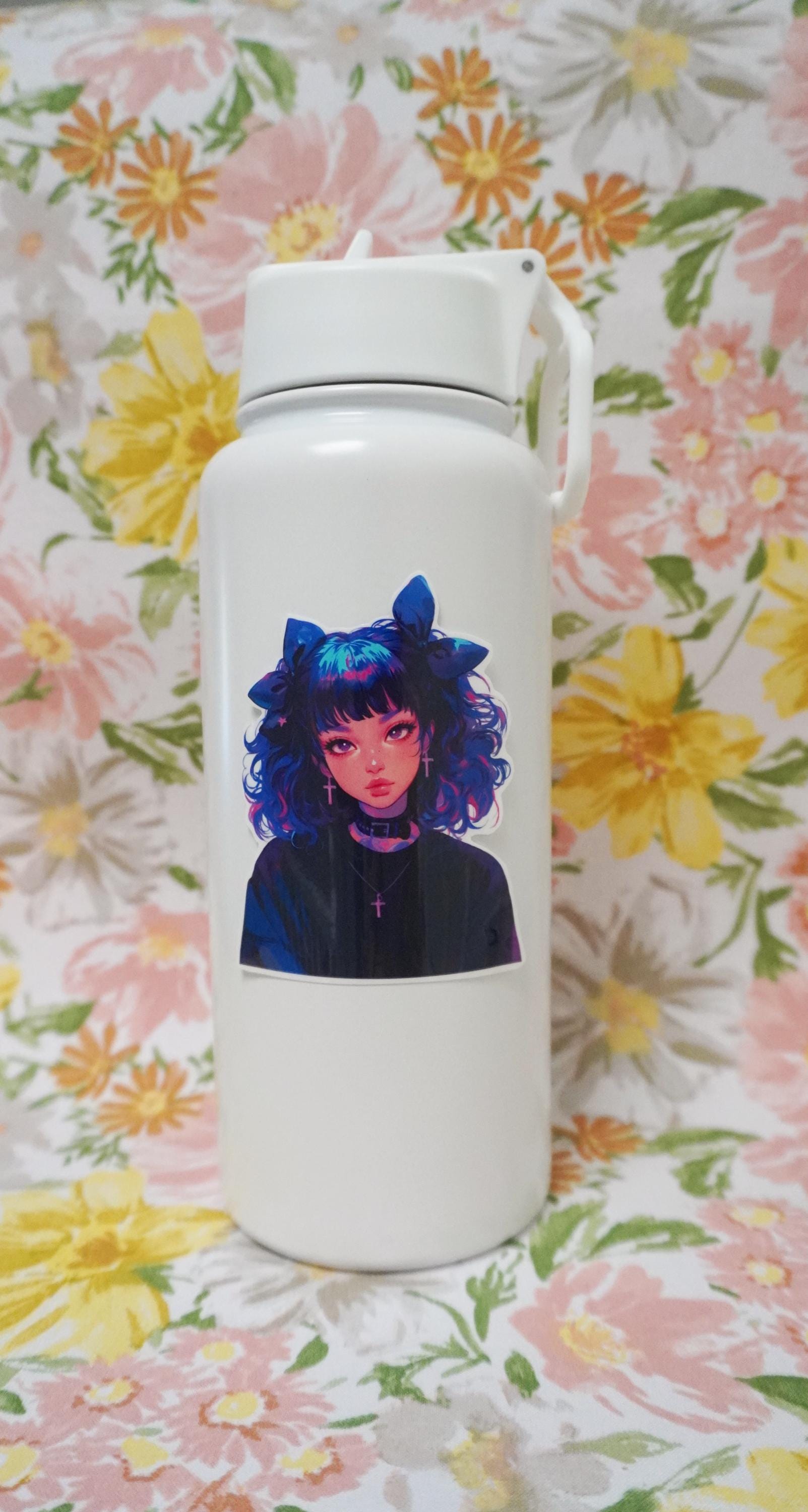 A white water bottle with a sticker of an anime-style character with curly blue and pink hair, large bows, cross earrings, and a black choker, set against a floral-patterned background.