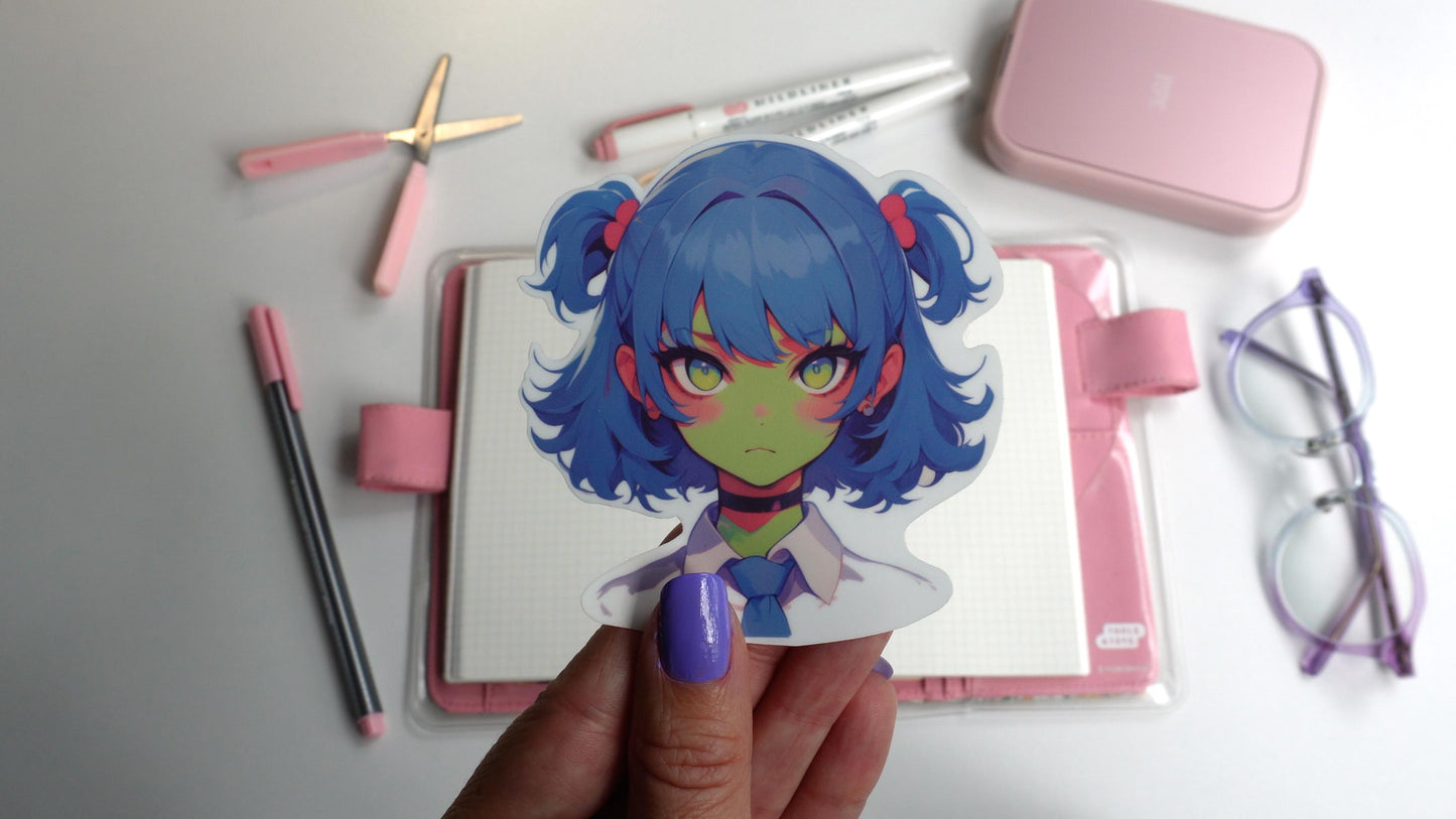A sticker of an anime-style character with blue twin-tails, pink hair ties, green skin, and yellow eyes, wearing a white shirt, blue tie, and black choker. The sticker is held up by a hand with purple-painted nails.