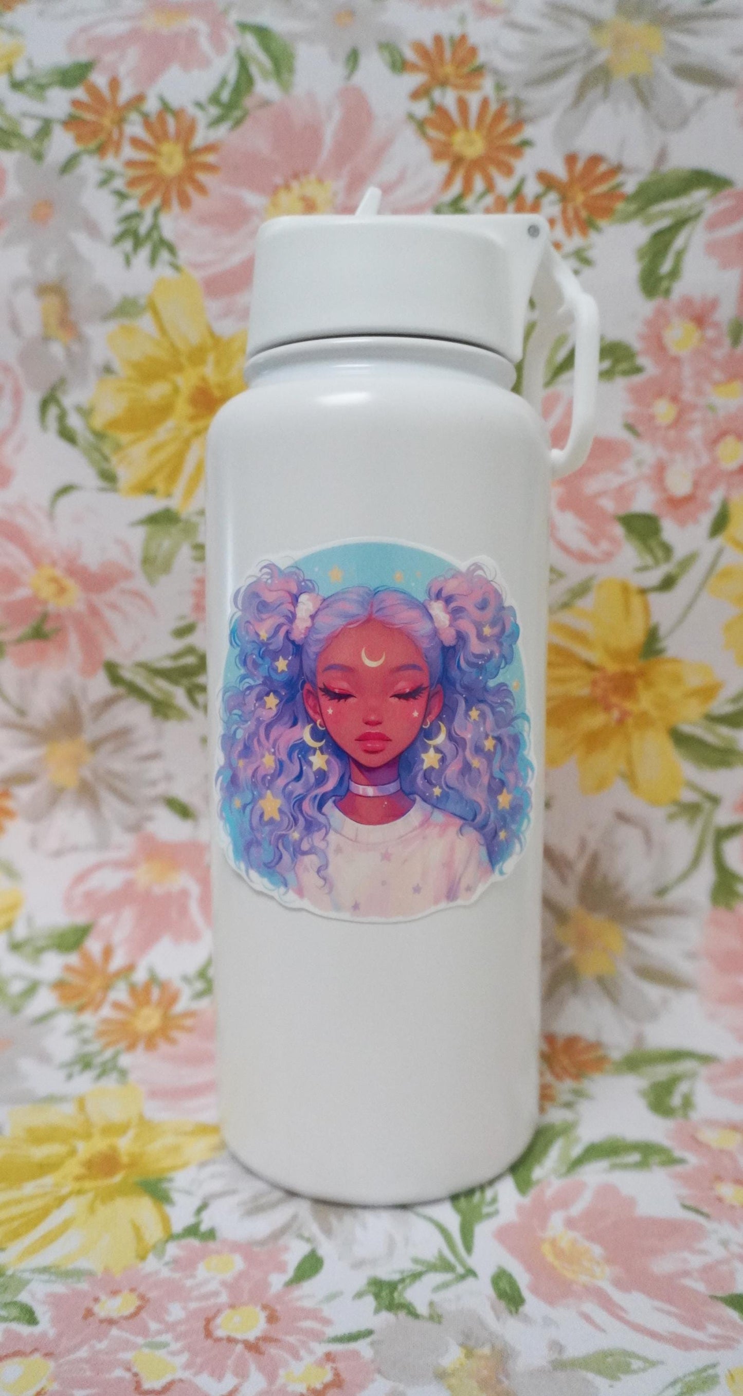 A white water bottle with an anime-style sticker of a girl with lavender and blue curly hair, eyes closed, and a crescent moon on her forehead, set against a floral-patterned background.