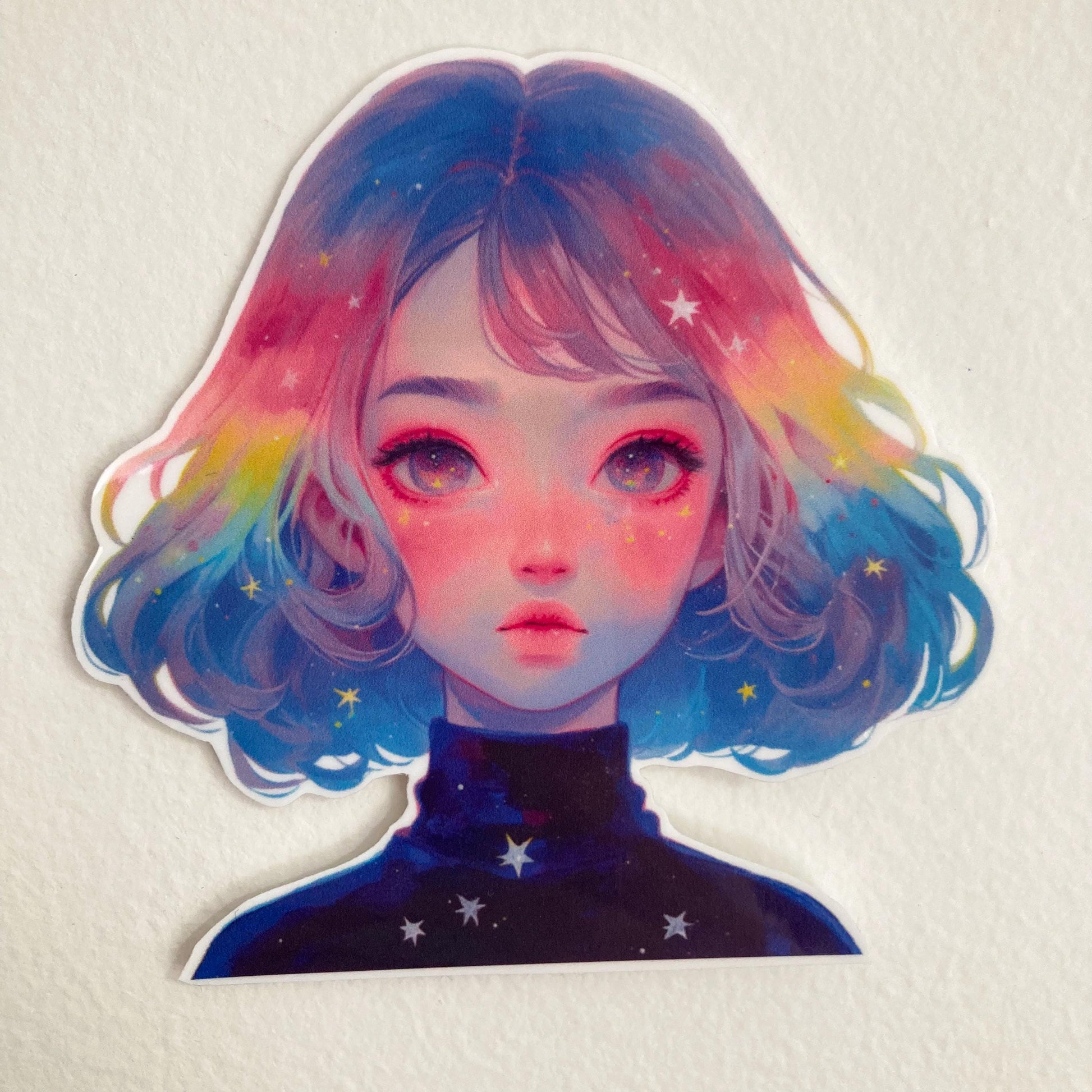 A colorful sticker of a person with pastel rainbow hair and vibrant eyes, wearing a galaxy-themed shirt with star patterns, set against a plain white background.